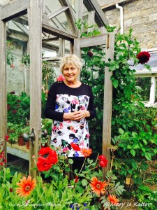 Helen in her elegant and simple potting shed/green house where plants wait for their turn in the garden. 